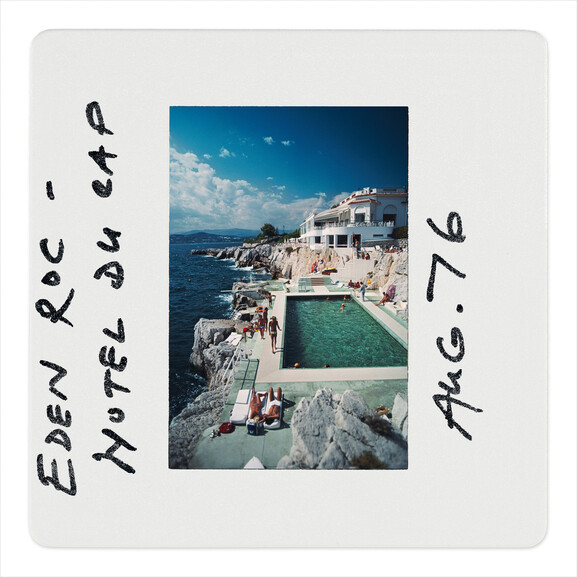 Photographic slide showing a hotel swimming pool and people beside the Mediterranean Sea.